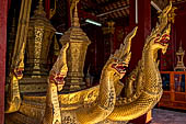 Wat Xieng Thong temple in Luang Prabang, Laos. Detail of flame-like gilded lacquered carvings of sacred serpents or nagas on the Royal Funerary Chariot. 